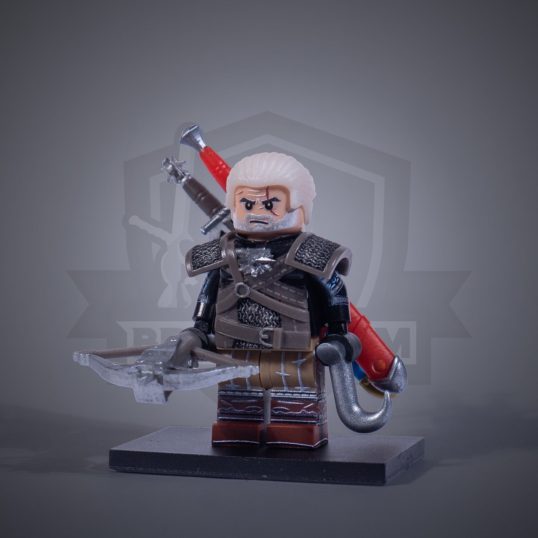 Toy figure of a Witcher with armor and two swords on a gray background