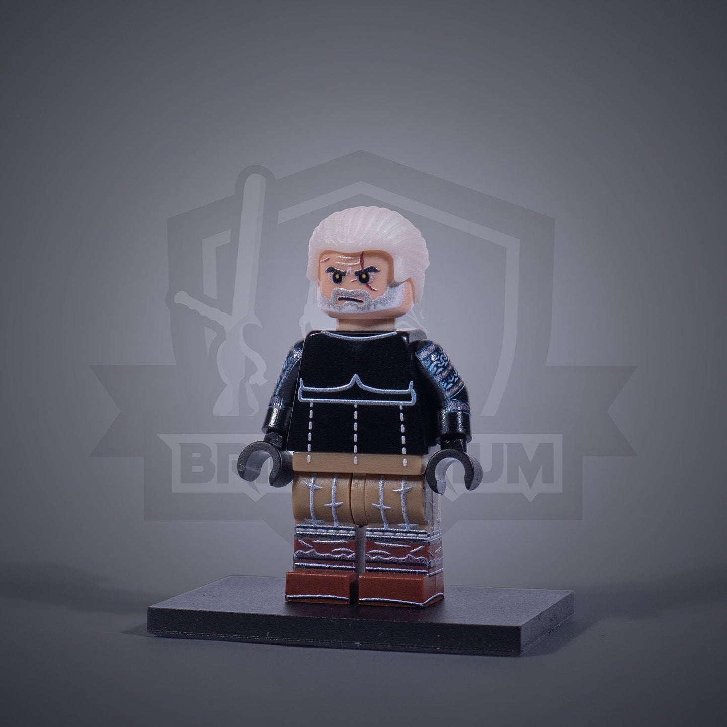 Toy figure of a Witcher without armor on a gray background