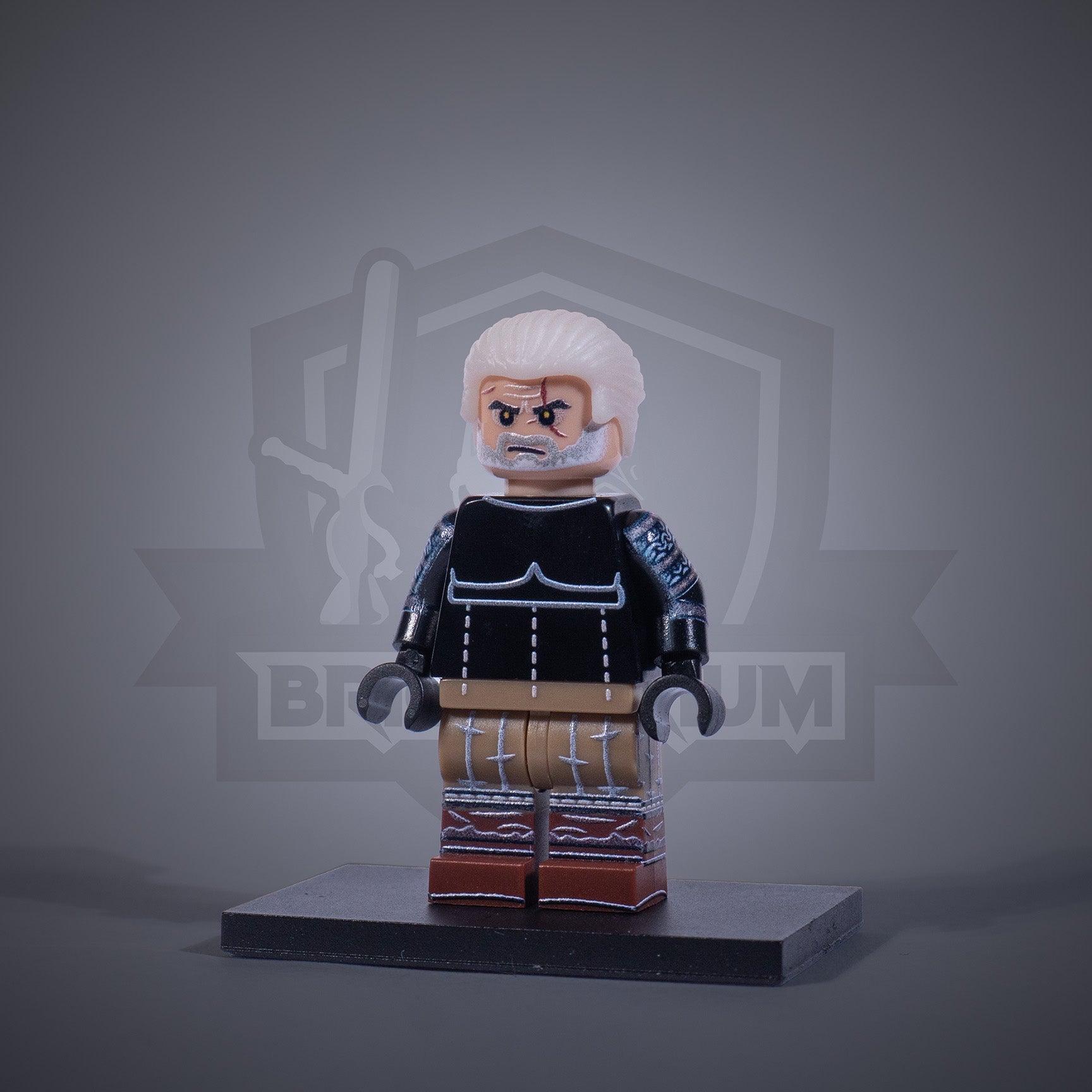 Toy figure of a Witcher without armor on a gray background