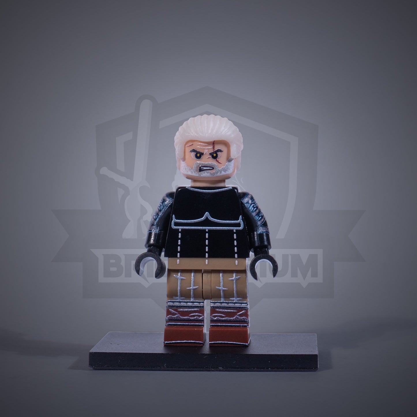 Toy figure of a Witcher without armor on a gray background