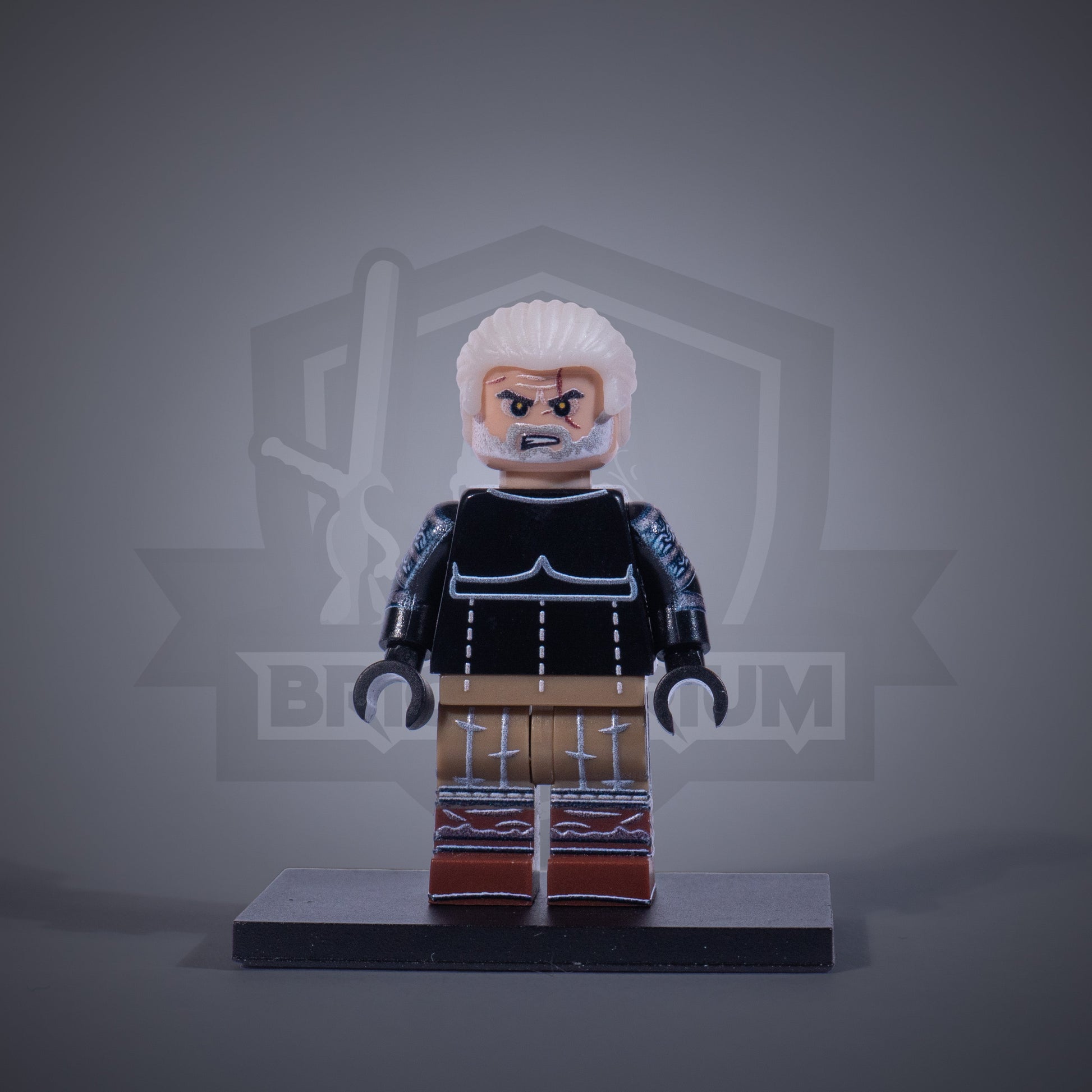 Toy figure of a Witcher without armor on a gray background
