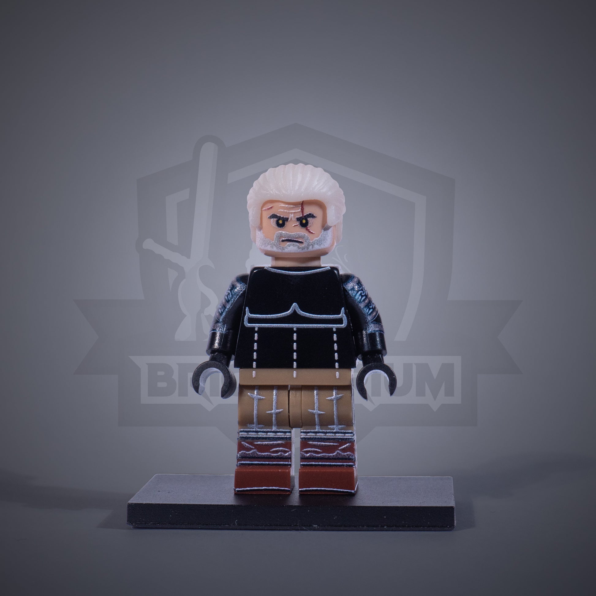 Toy figure of a Witcher without armor on a gray background
